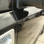 Before and after photographs of a damaged, black, Range Rover that was repaired by Elite Paint & Body Shop in West Palm Beach, FL.